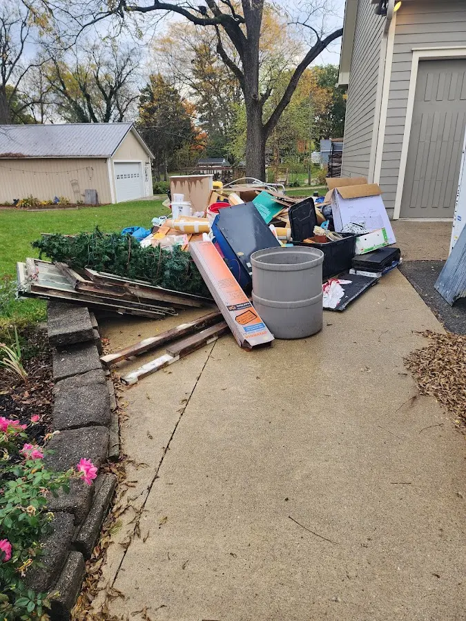 Dumpster being loaded with debris for Estate Cleanout Dumpster Rental in Schenectady